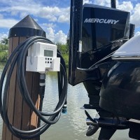 MarineWarehouse/Flushmaster-2-Outlet-Automated-Outboard-Flushing-System-installed-on-a-dock-with-a-Mercury-Outboard__01787.1739477316